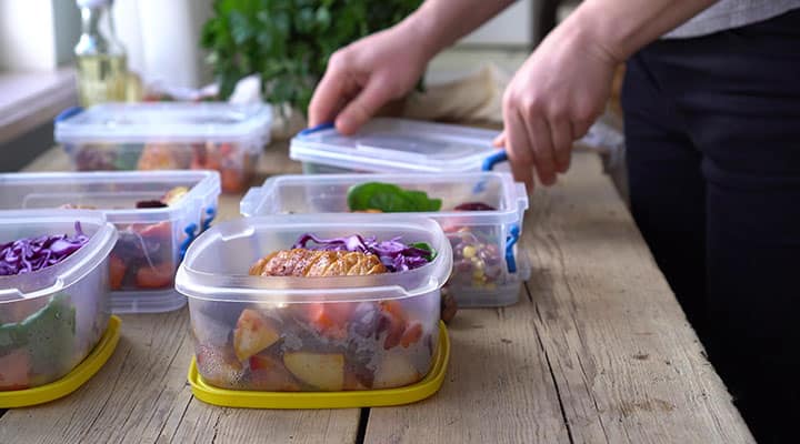 Man packing pre-made healthy meals at home