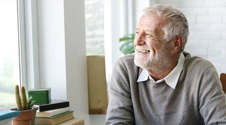 Older man, on magnesium regiment that can improve short and long term memory, looking out the window