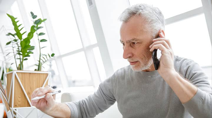 Focused man who energizes his brain with acetyl-l-carnitine talking on the phone