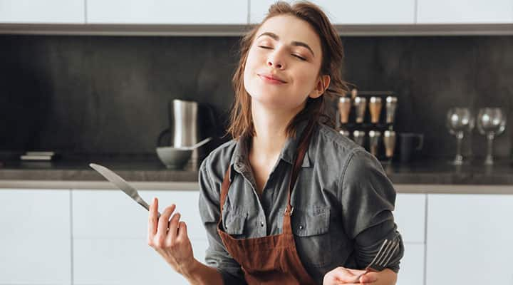 Young woman enjoying a fish oil-rich meal that supplies omega-3 fatty acids EPA and DHA