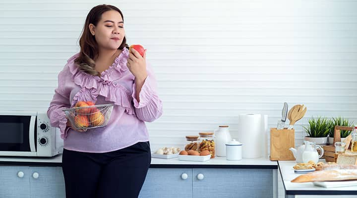 Woman eating apples as a healthy snack