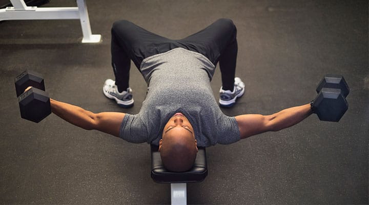 Man weight training on a workout bench