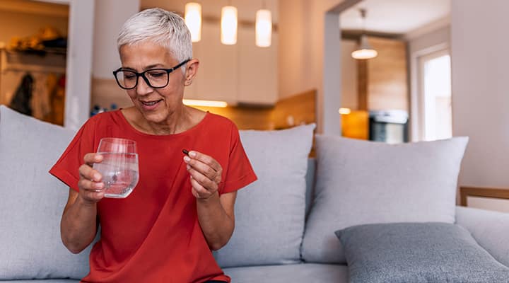 Woman taking a collagen supplement