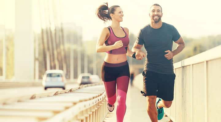 Healthy couple using Ashwagandha's health benefits jogging outside