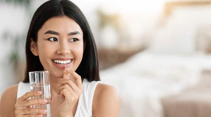 Woman taking an ashwagandha supplement