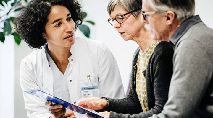 Man and woman talking to doctor