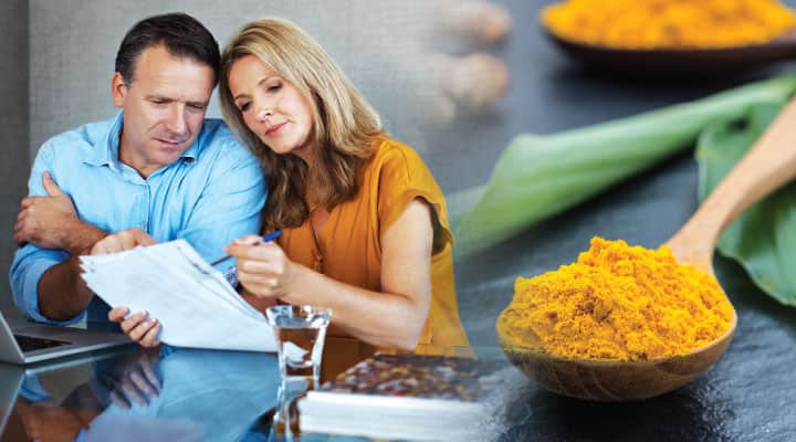 Husband and wife looking over papers after taking curcumin