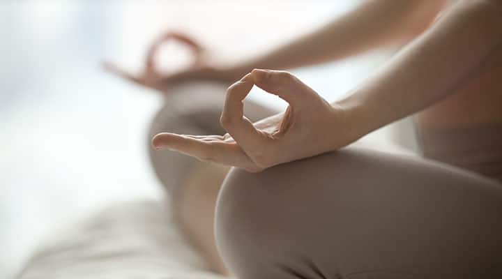 Woman sitting in a meditating position