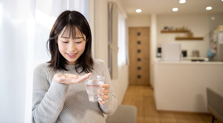 Woman considering her vegan supplement