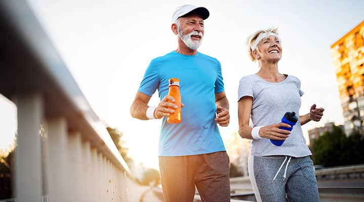 Older couple exercising outside for benefit