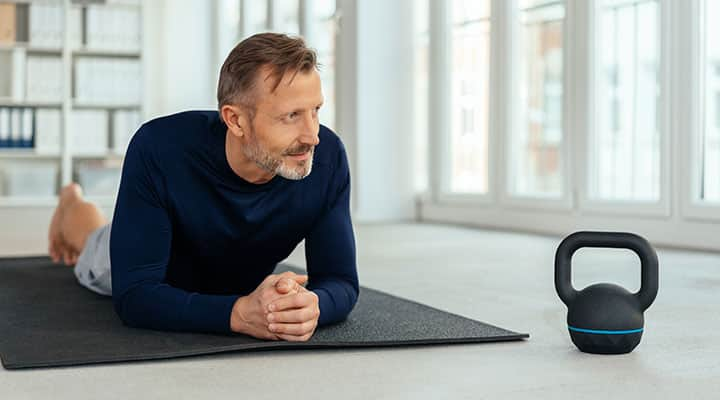 Man on yoga mat working out with improved testosterone